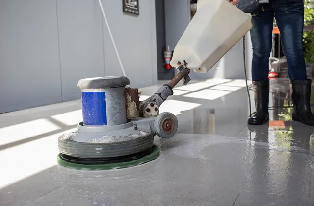 Machine scrubbing a tile floor